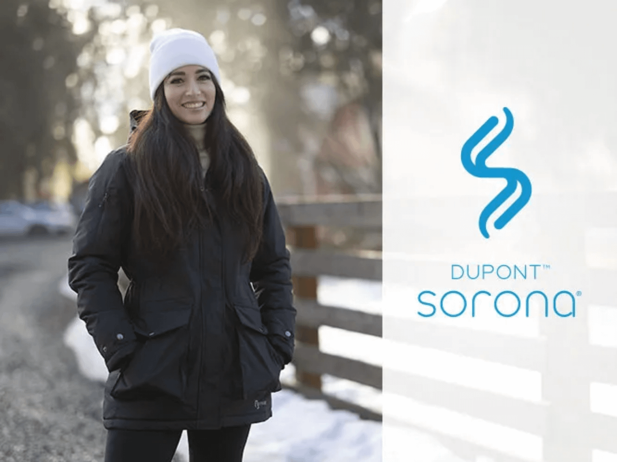 Woman in winter clothes smiling, DuPont Sorona logo